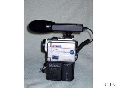Shotgun microphone mounted on videocamera.